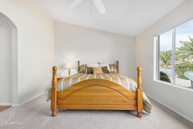 carpeted bedroom featuring ceiling fan, lofted ceiling, and multiple windows