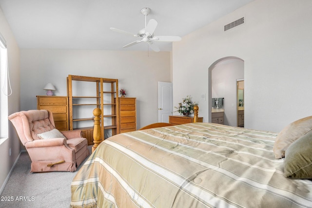 carpeted bedroom with ceiling fan and ensuite bathroom