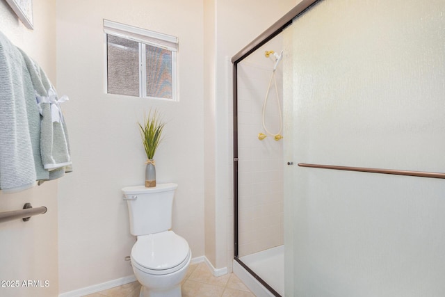 bathroom with toilet, tile patterned flooring, and a shower with door