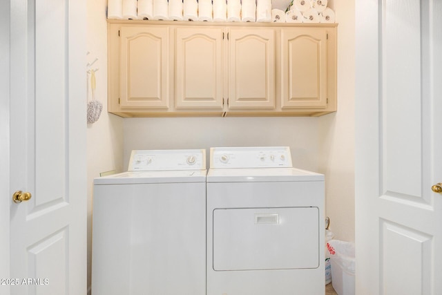 laundry room featuring independent washer and dryer and cabinets