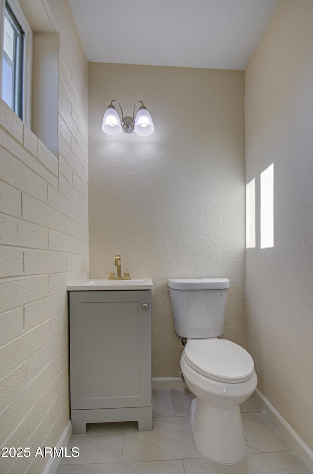 bathroom featuring tile patterned floors, vanity, and toilet