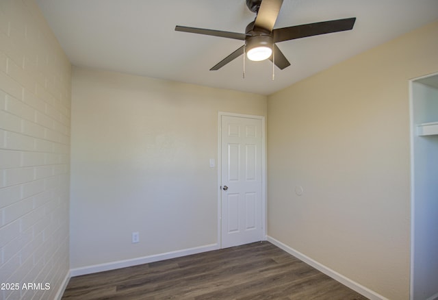 empty room with dark hardwood / wood-style floors and ceiling fan