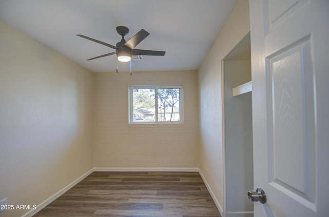 unfurnished room with dark hardwood / wood-style floors and ceiling fan