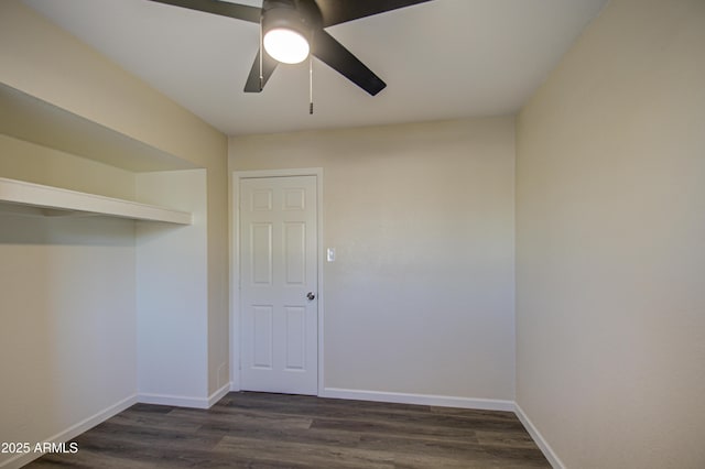 unfurnished room featuring ceiling fan and dark hardwood / wood-style flooring