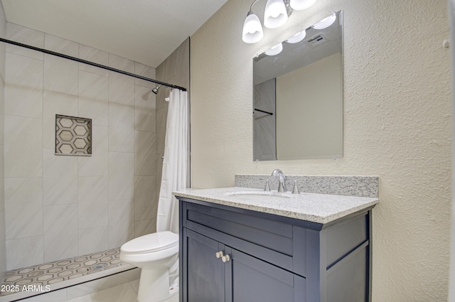 bathroom featuring tile patterned flooring, a shower with curtain, vanity, and toilet