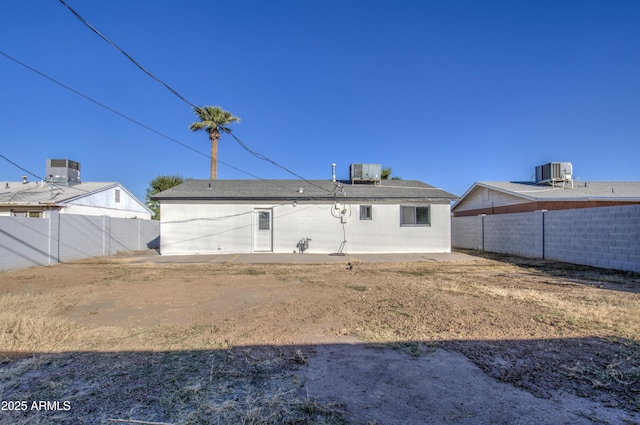 rear view of house with central AC