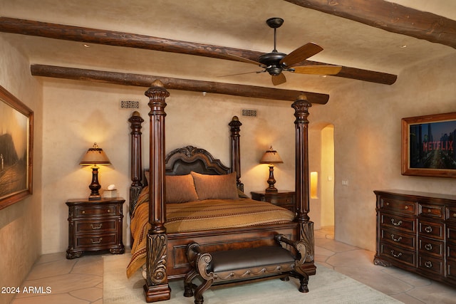 tiled bedroom featuring ceiling fan and beamed ceiling