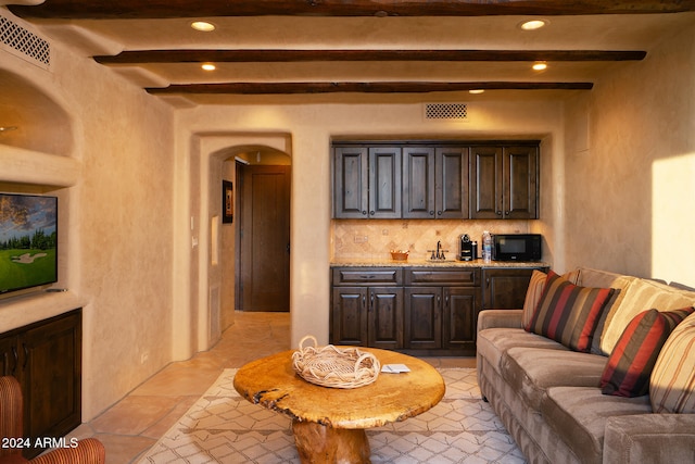 living room with sink and beamed ceiling