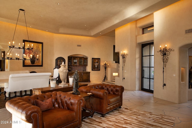 living room with light tile patterned flooring and a chandelier