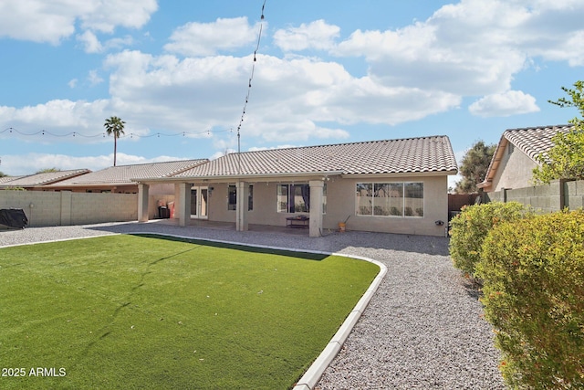 back of property featuring a patio, a fenced backyard, stucco siding, and a tile roof