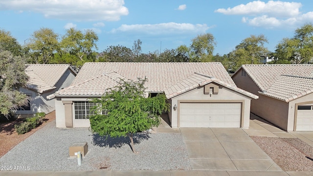 ranch-style home featuring an attached garage, concrete driveway, stucco siding, and a tile roof