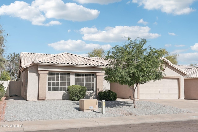 view of front facade featuring a garage, driveway, stucco siding, and a tile roof