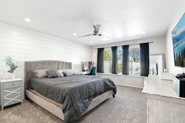 carpeted bedroom with ceiling fan and baseboards