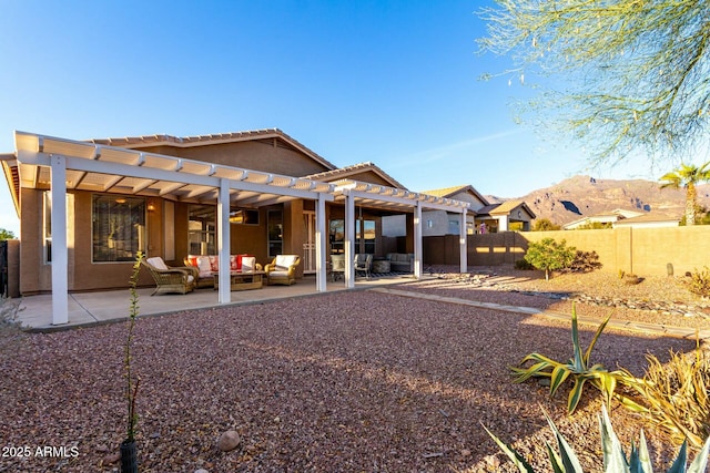 back of house featuring a mountain view, a pergola, an outdoor hangout area, and a patio