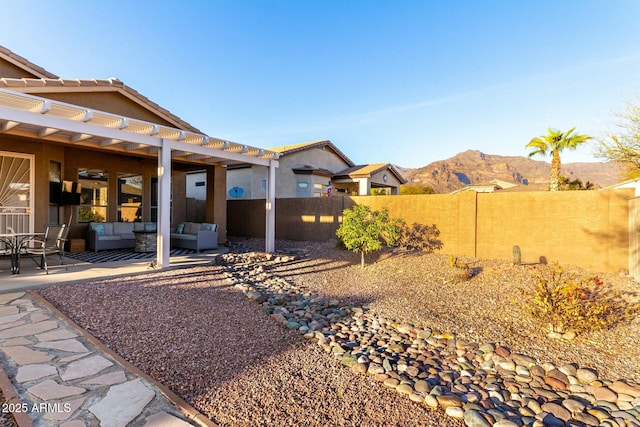 view of yard featuring an outdoor living space, a mountain view, and a patio area