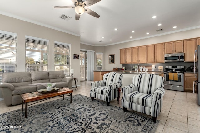 living room featuring light tile patterned floors, ornamental molding, sink, and ceiling fan