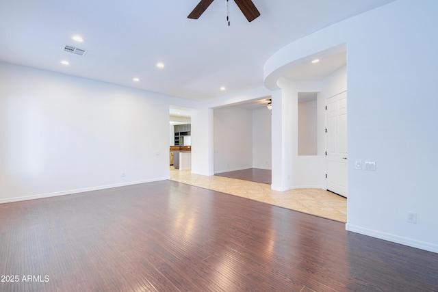 empty room featuring ceiling fan and light hardwood / wood-style flooring