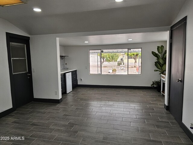 kitchen with lofted ceiling, recessed lighting, baseboards, dishwasher, and wood tiled floor