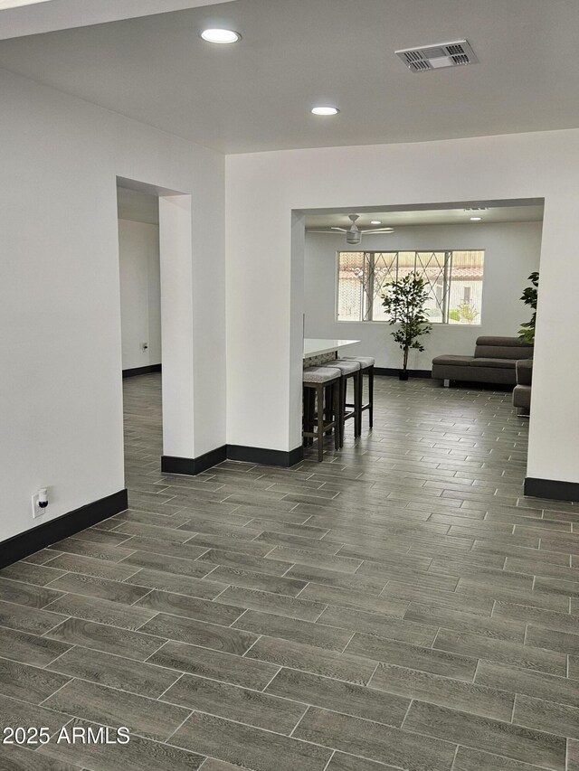 unfurnished dining area with visible vents, baseboards, and wood tiled floor