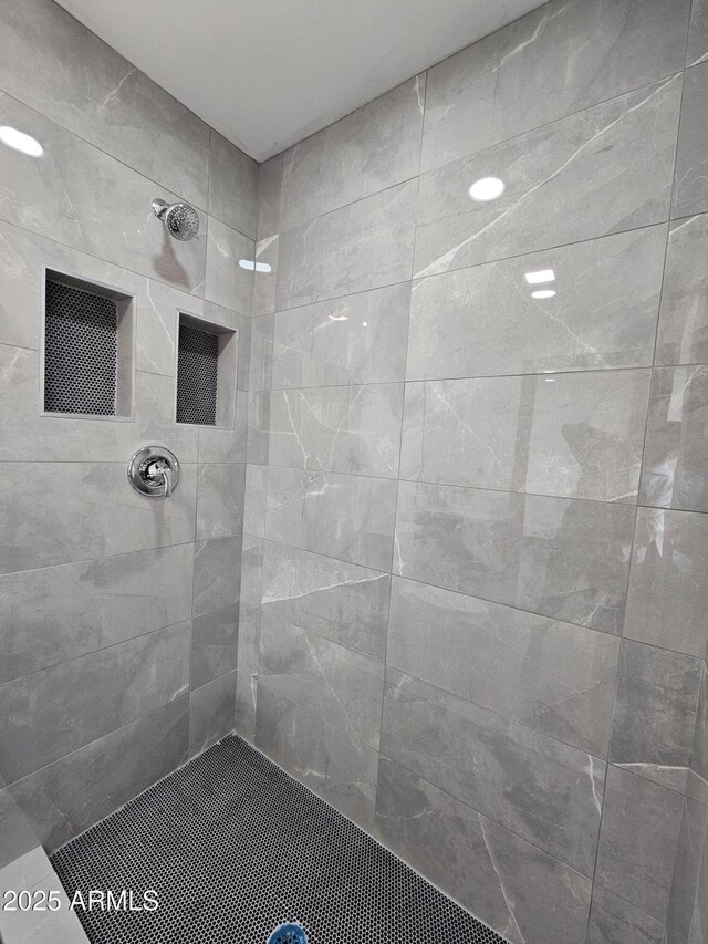 bathroom with a tile shower