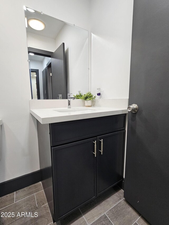 bathroom featuring baseboards and vanity