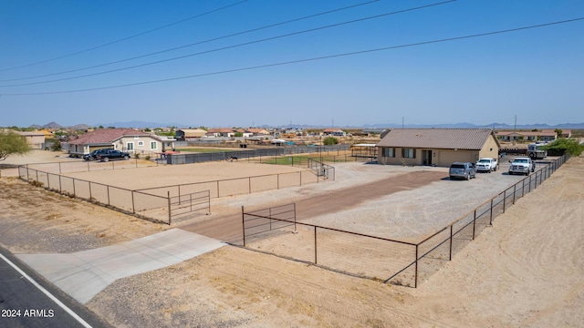 exterior space featuring an enclosed area, a residential view, and fence