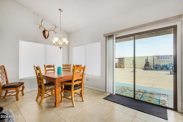 dining area with lofted ceiling, light tile patterned floors, baseboards, and a chandelier