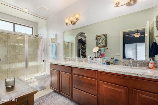 full bath featuring a shower stall, double vanity, and a sink