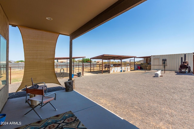 view of patio featuring an outbuilding and an exterior structure