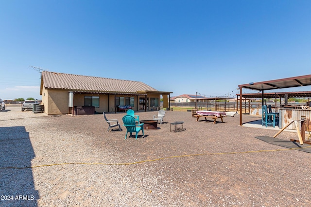 exterior space with an outdoor fire pit and fence