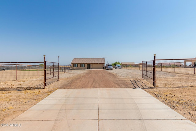 view of front facade featuring a gate, fence, and driveway