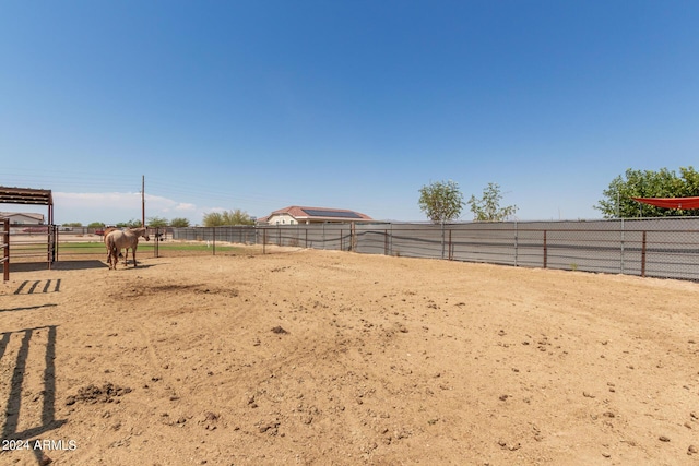 view of yard featuring a rural view and an enclosed area