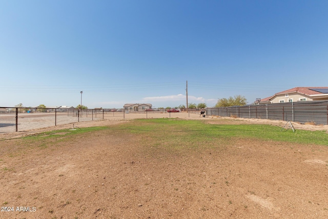 view of yard featuring a rural view and fence