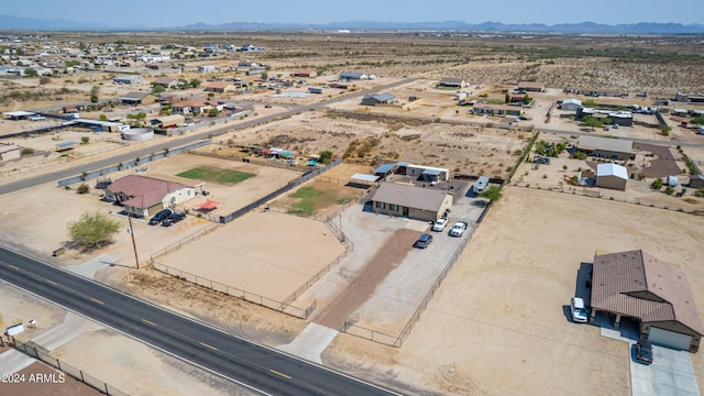 drone / aerial view featuring a mountain view and a desert view