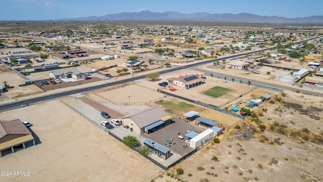 birds eye view of property with a mountain view and view of desert