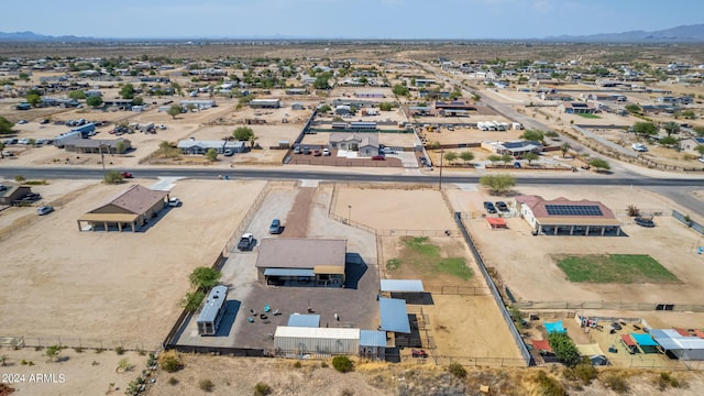 birds eye view of property with a mountain view and view of desert