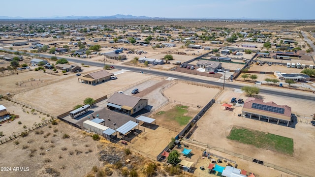 drone / aerial view featuring a mountain view and a desert view