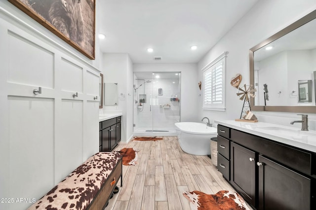 bathroom with independent shower and bath and vanity