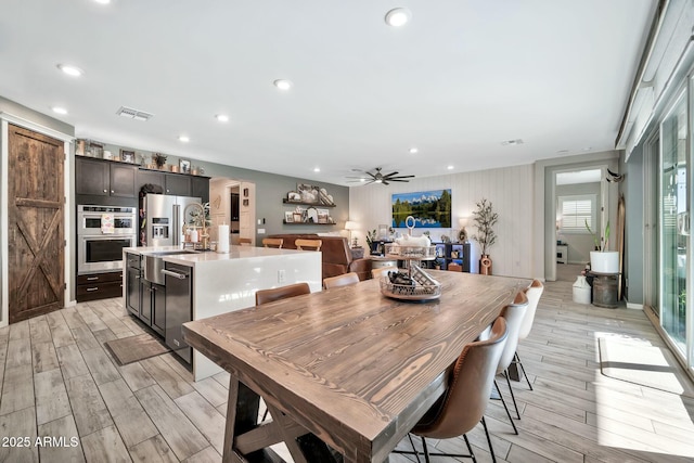 dining area featuring ceiling fan and sink