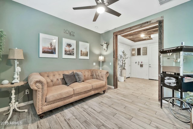 living room featuring light hardwood / wood-style floors and ceiling fan