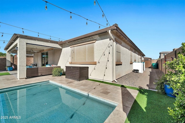 rear view of house featuring a fenced in pool, an outdoor living space, and a patio