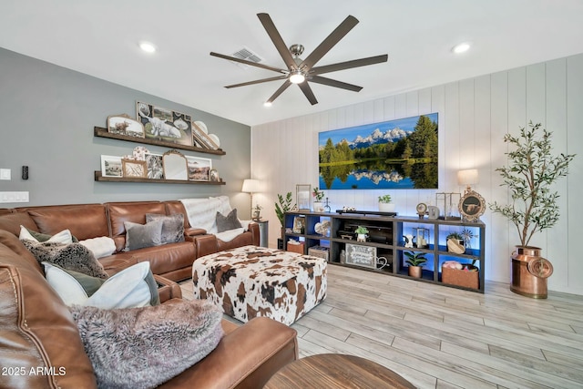 living room featuring ceiling fan and light wood-type flooring