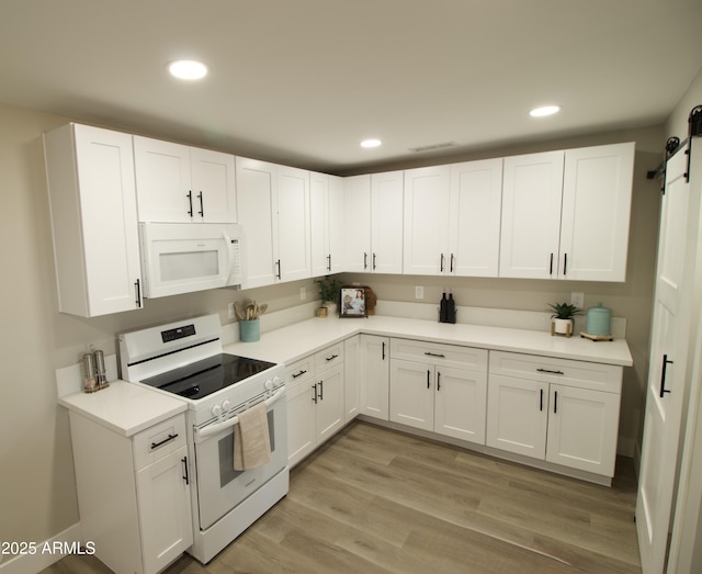 2573 E Superstition Blvd, Apache Junction, AZ 85119 - kitchen featuring white appliances, white cabinetry, recessed lighting, a barn door, and light countertops