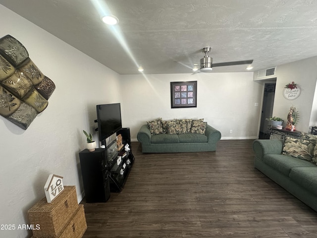 living area featuring baseboards, visible vents, wood finished floors, a textured ceiling, and recessed lighting