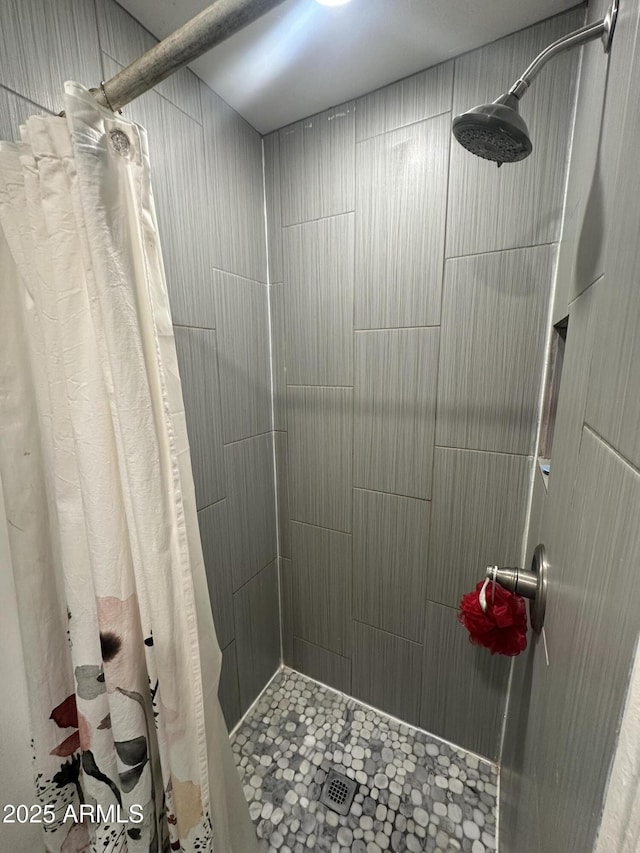 bathroom with a tile shower