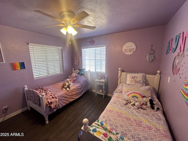 bedroom featuring a textured ceiling, ceiling fan, wood finished floors, and baseboards