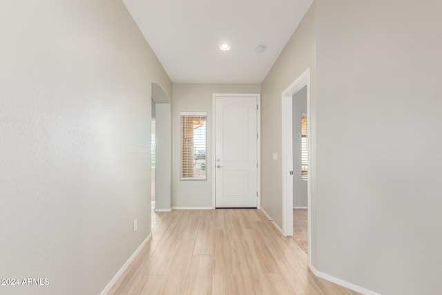 corridor with light hardwood / wood-style flooring