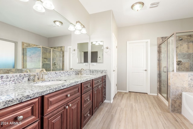 bathroom featuring vanity and separate shower and tub