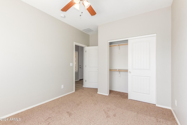 unfurnished bedroom featuring a closet, ceiling fan, and light colored carpet