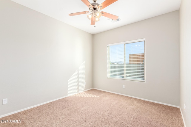 spare room featuring ceiling fan and light carpet